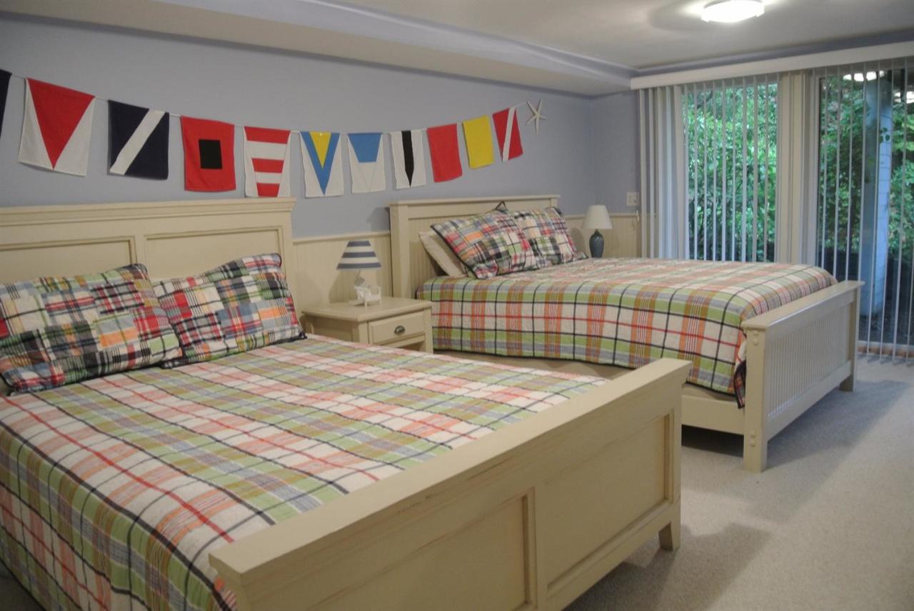 118 Wading Place Road Mashpee, MA 02649 - Photo 21 of 32 a bedroom with a bed and a large window