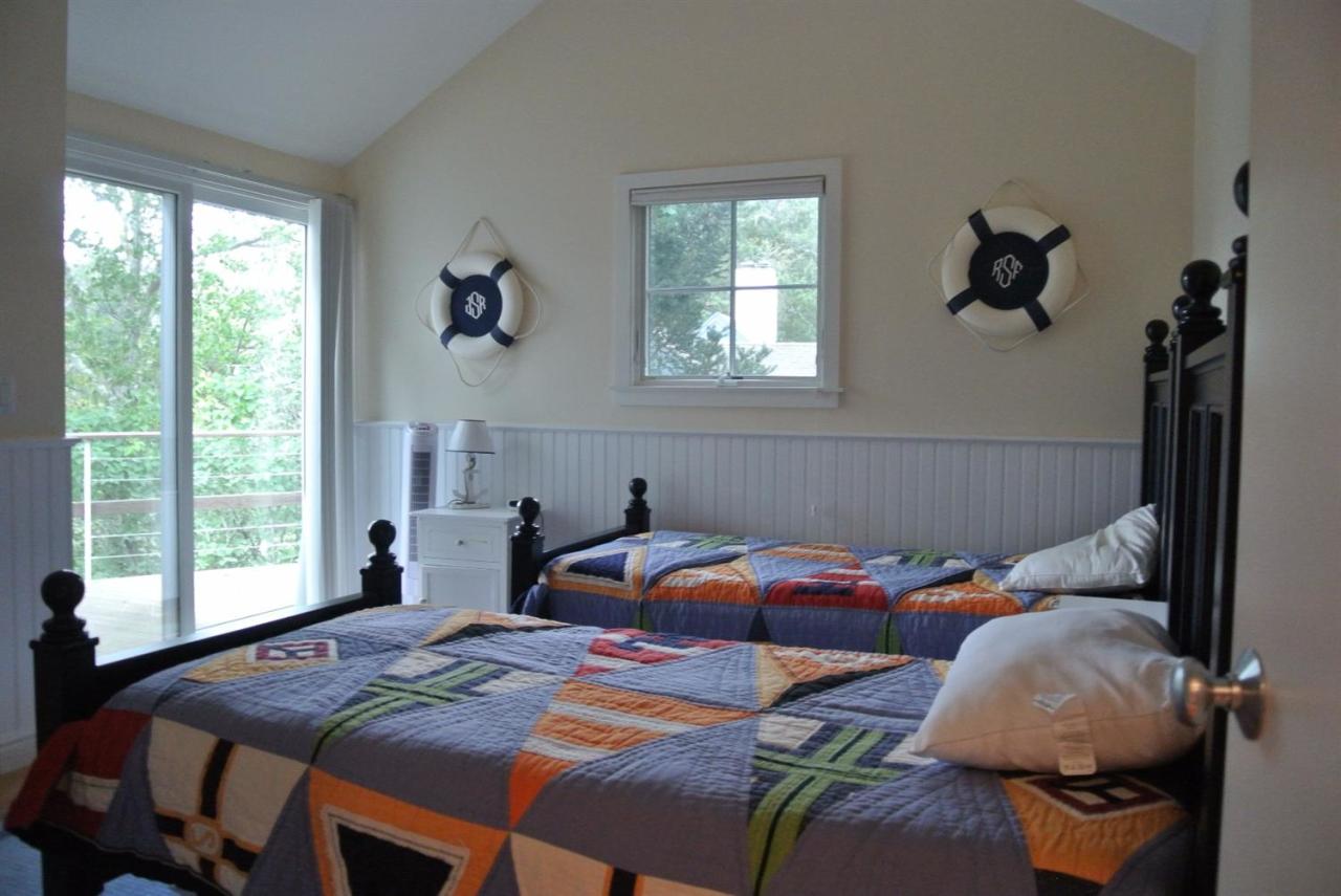 118 Wading Place Road Mashpee, MA 02649 - Photo 22 of 32 a bedroom with two beds and a window