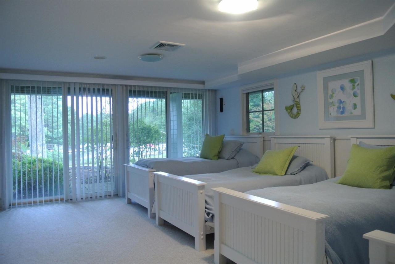 118 Wading Place Road Mashpee, MA 02649 - Photo 23 of 32 a bedroom with a bed and a painting on the wall