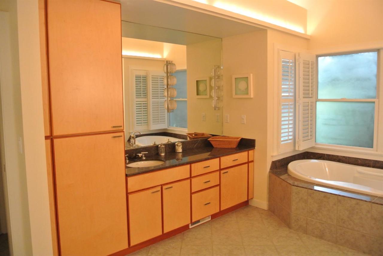 118 Wading Place Road Mashpee, MA 02649 - Photo 24 of 32 a bathroom with a granite countertop sink and a bathtub