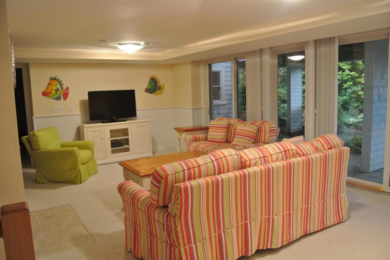 118 Wading Place Road Mashpee, MA 02649 - Photo 27 of 32 a bedroom with a bed and a television