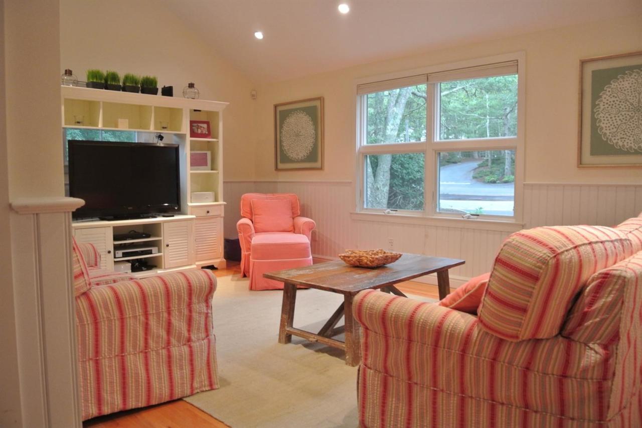 118 Wading Place Road Mashpee, MA 02649 - Photo 29 of 32 a bedroom with furniture and a flat screen tv
