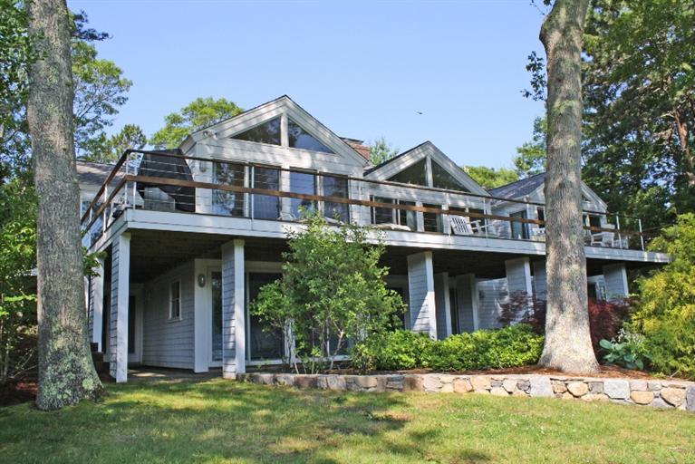 118 Wading Place Road Mashpee, MA 02649 - Photo 4 of 32 a front view of a house with a yard