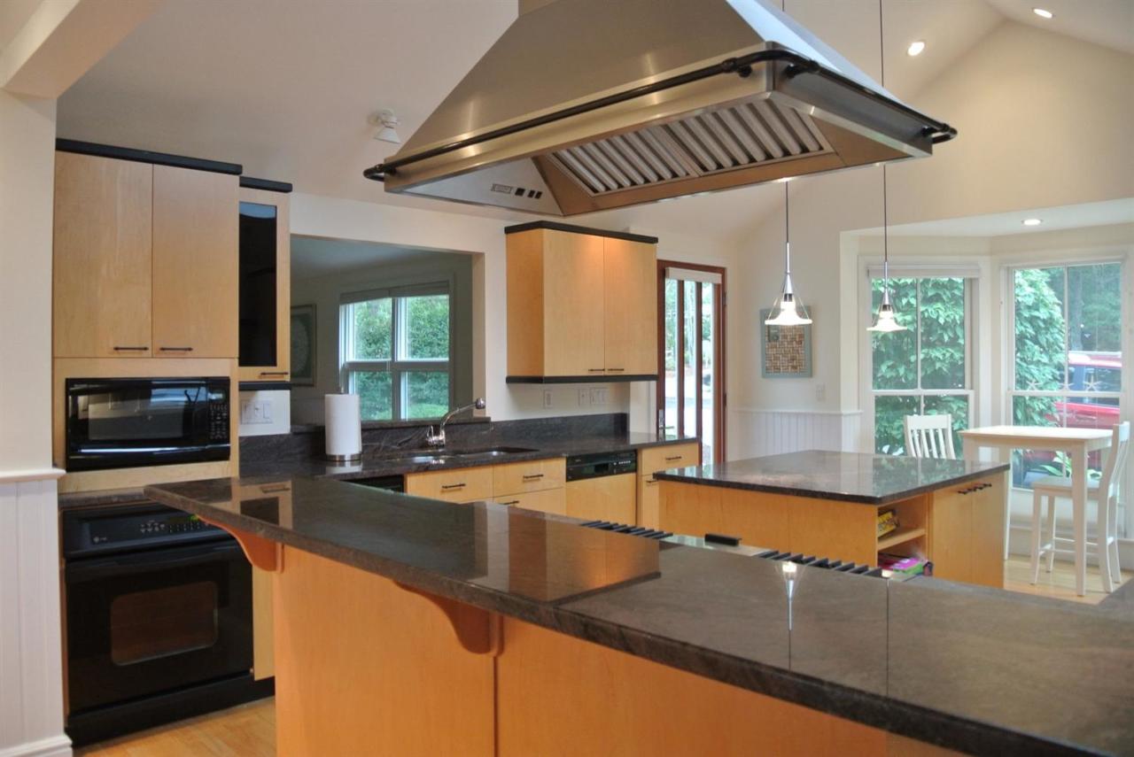 118 Wading Place Road Mashpee, MA 02649 - Photo 8 of 32 a kitchen with stainless steel appliances granite countertop a sink a stove and a microwave oven with granite countertops