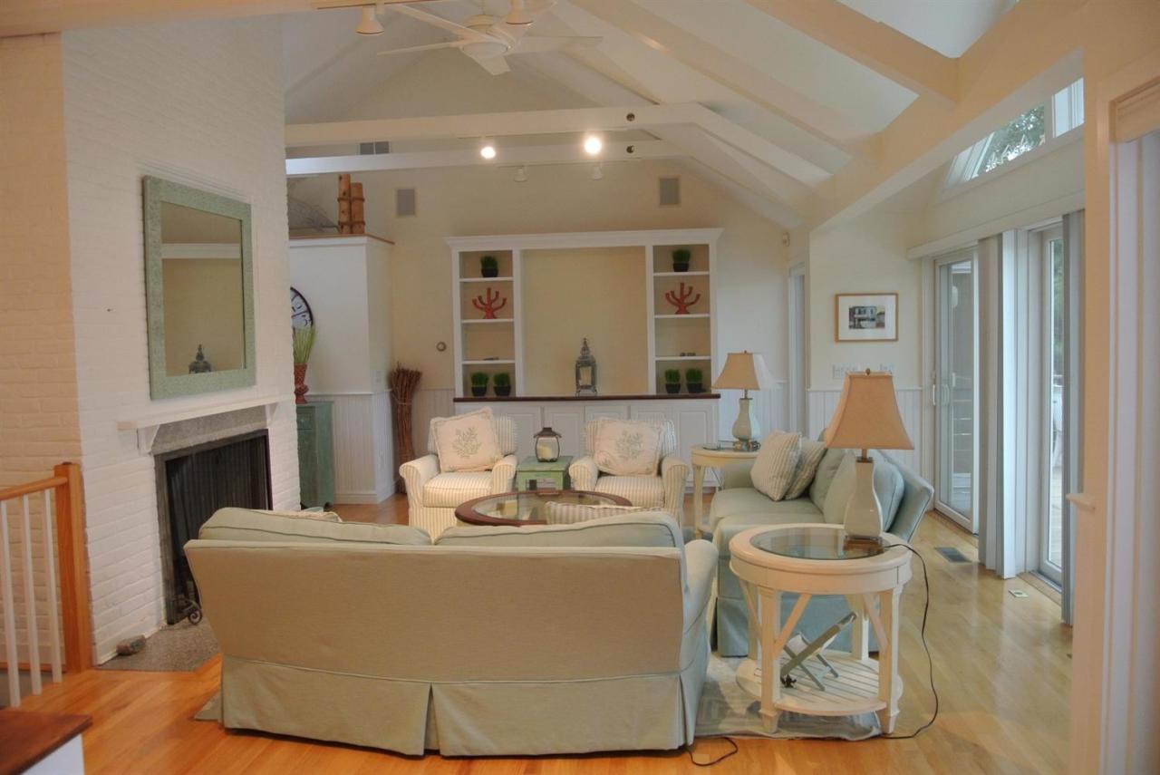 118 Wading Place Road Mashpee, MA 02649 - Photo 10 of 32 a living room with furniture and a fireplace
