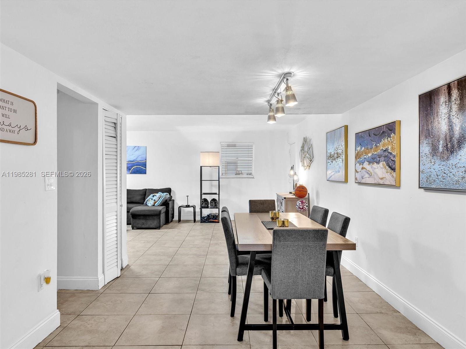 1236 Alton Road, Unit 304 Miami Beach, FL 33139 - Photo 10 of 28 a view of a dining room with furniture and a livingroom