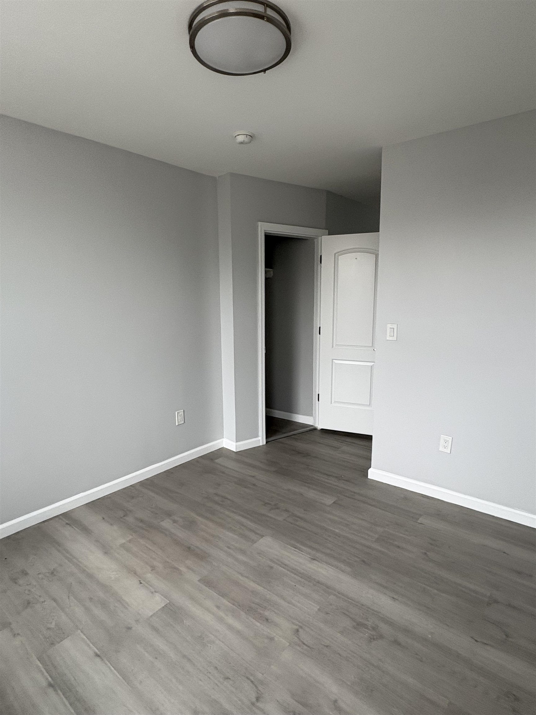 17 Teaneck Road, Unit 3C Ridgefield Park, NJ 07660 - Photo 5 of 8 a view of an empty room with wooden floor