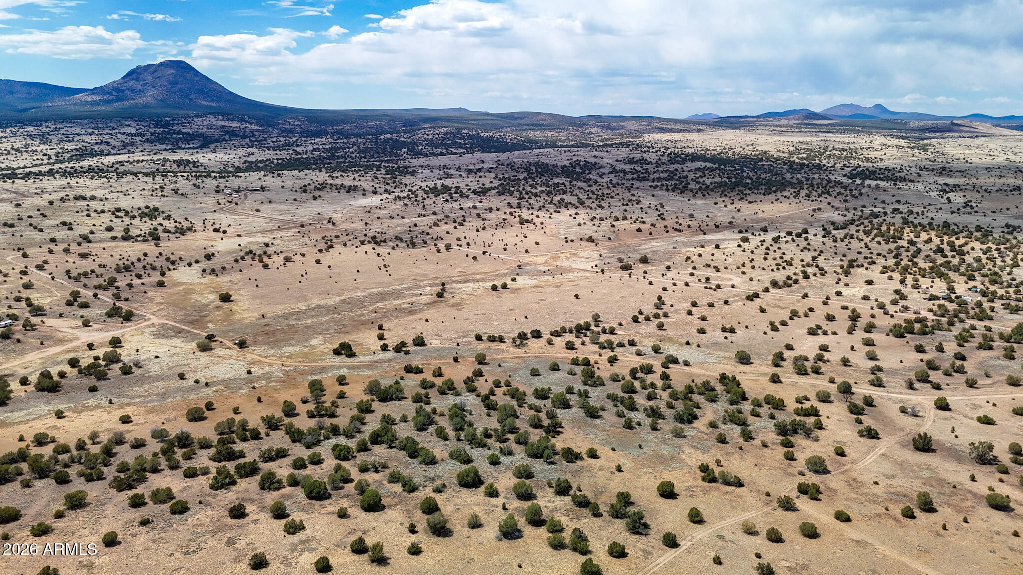0 West Mile High Road, Unit 84 Ash Fork, AZ 86320 - Photo 9 of 25 a view of a dry yard with wooden floor and a mountain view