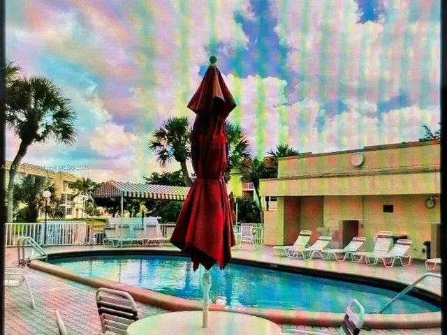 a front view of house with yard swimming pool and outdoor seating