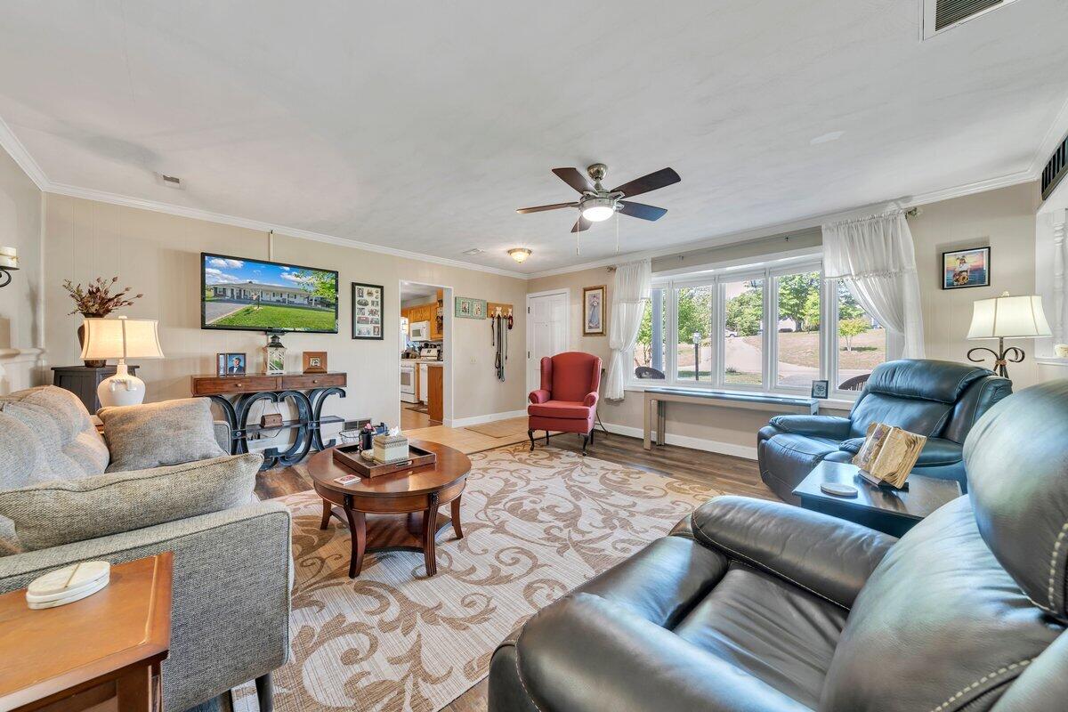 3226 Rakes Road Rocky Mount, VA 24151 - Photo 10 of 74 a living room with furniture a flat screen tv and a large window