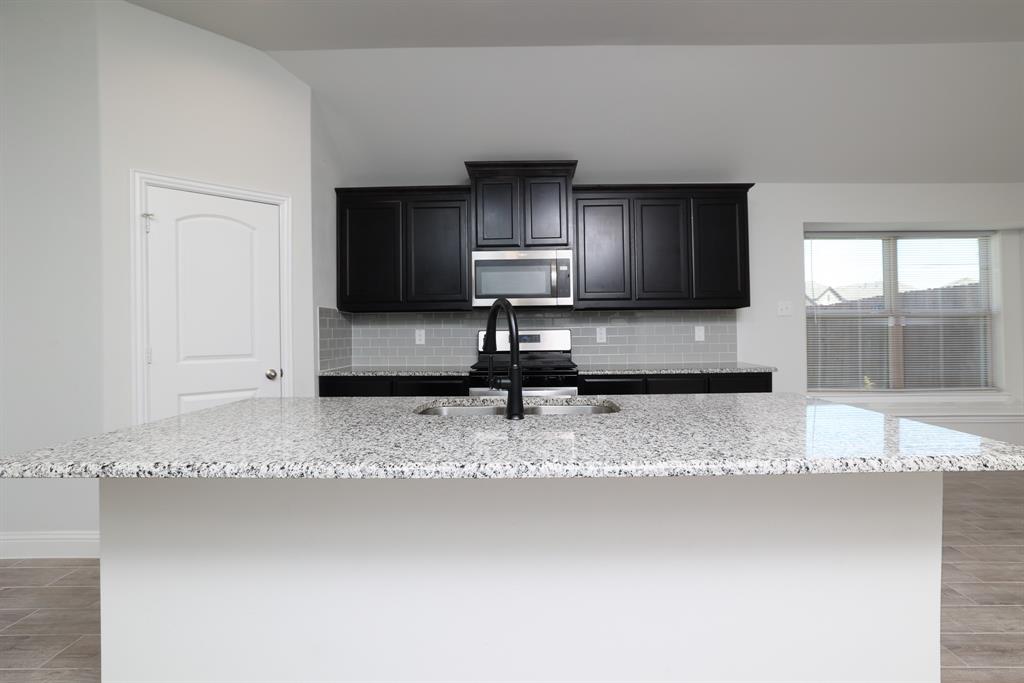 118 Sycamore Street Balch Springs, TX 75181 - Photo 15 of 34 a view of a kitchen with granite countertop a sink and a granite counter tops