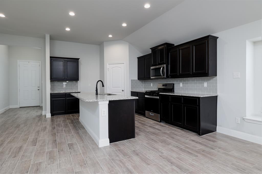 118 Sycamore Street Balch Springs, TX 75181 - Photo 16 of 34 a kitchen with granite countertop stainless steel appliances and cabinets