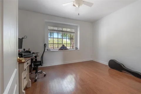 a living room with furniture and two windows