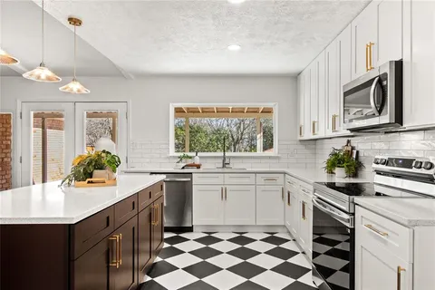 a kitchen with a sink stove and cabinets