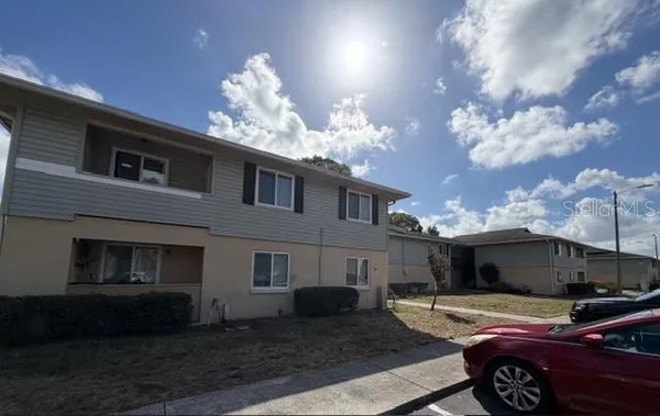 a view of a kitchen with wooden floor and a refrigerator