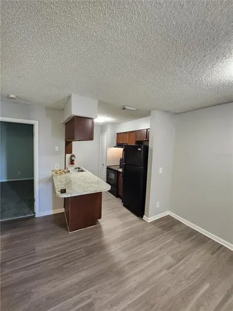 a view of living room with furniture and wooden floor