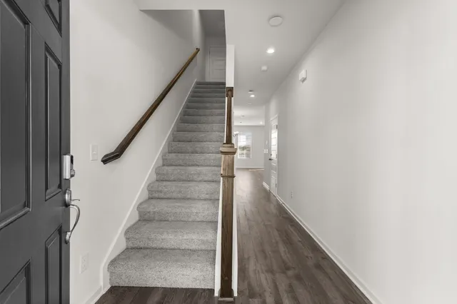a view of entryway and gallery with wooden floor