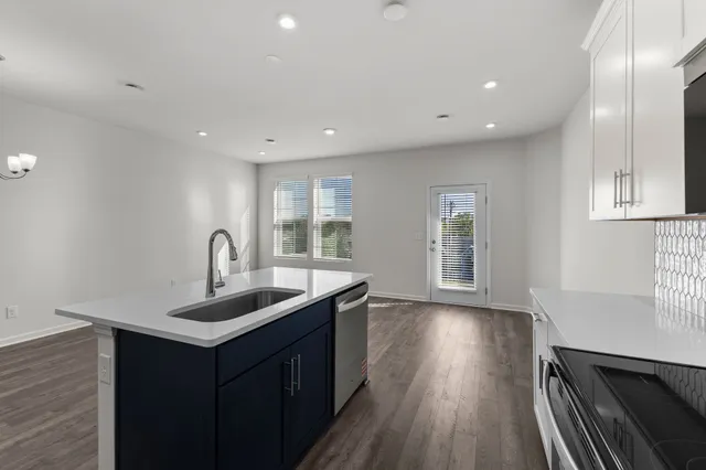 a kitchen with sink cabinets and wooden floor