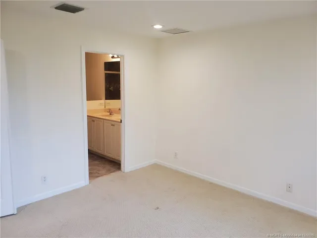 a view of a room with a hallway and closet