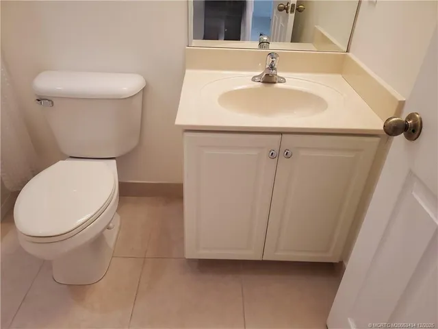 a bathroom with a white toilet and a sink