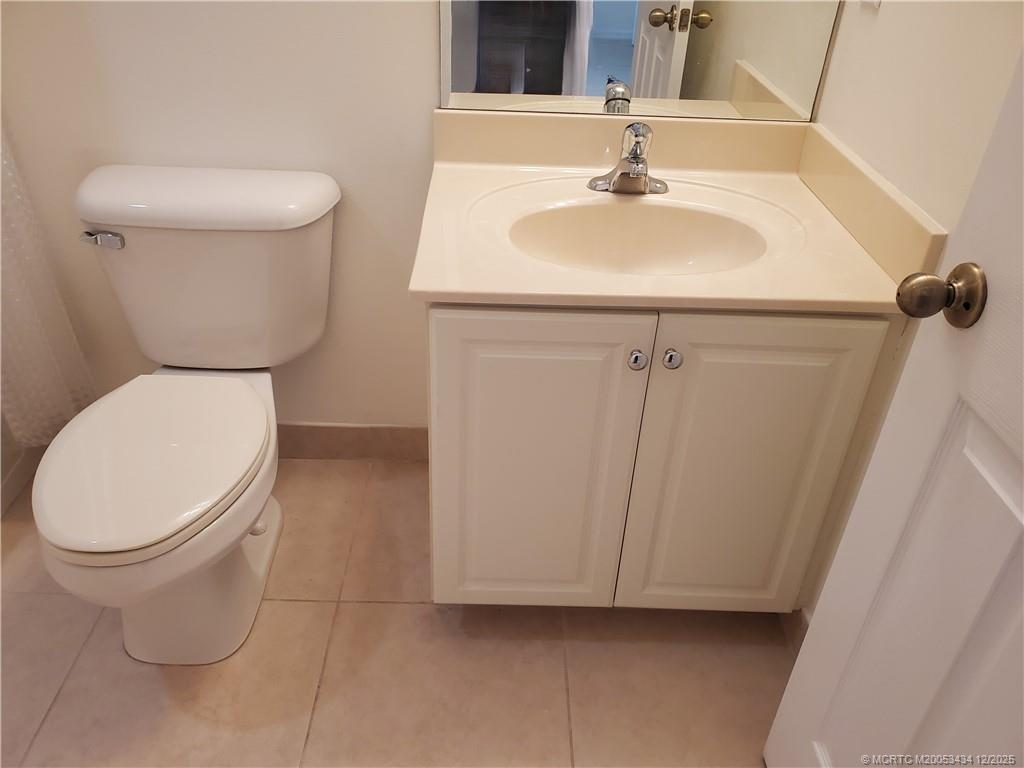 5309 Southeast Jennings Lane Stuart, FL 34997 - Photo 19 of 23 a bathroom with a sink a toilet and mirror