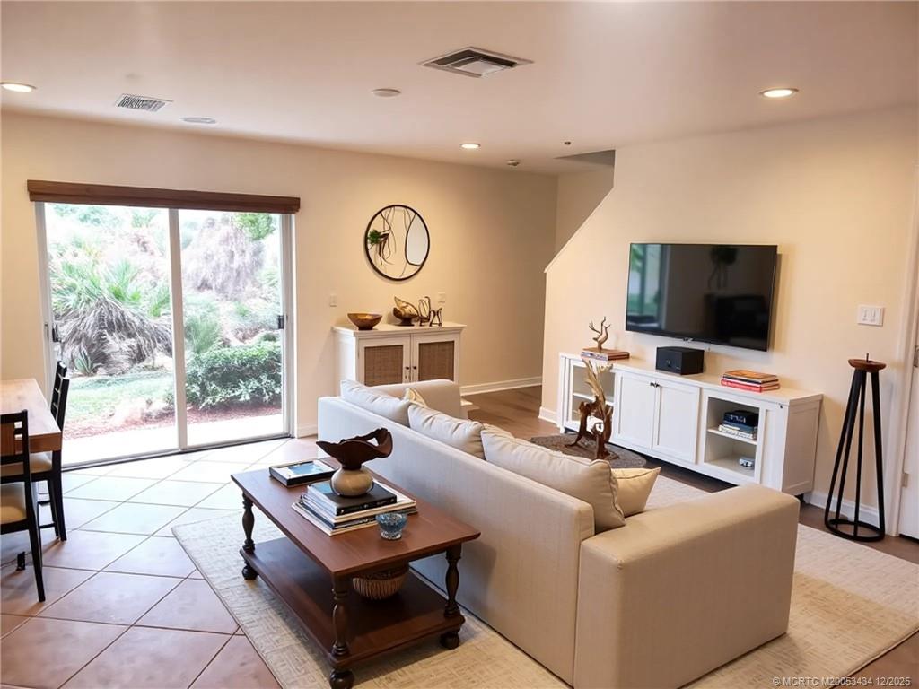 5309 Southeast Jennings Lane Stuart, FL 34997 - Photo 8 of 23 a living room with furniture a flat screen tv and a large window