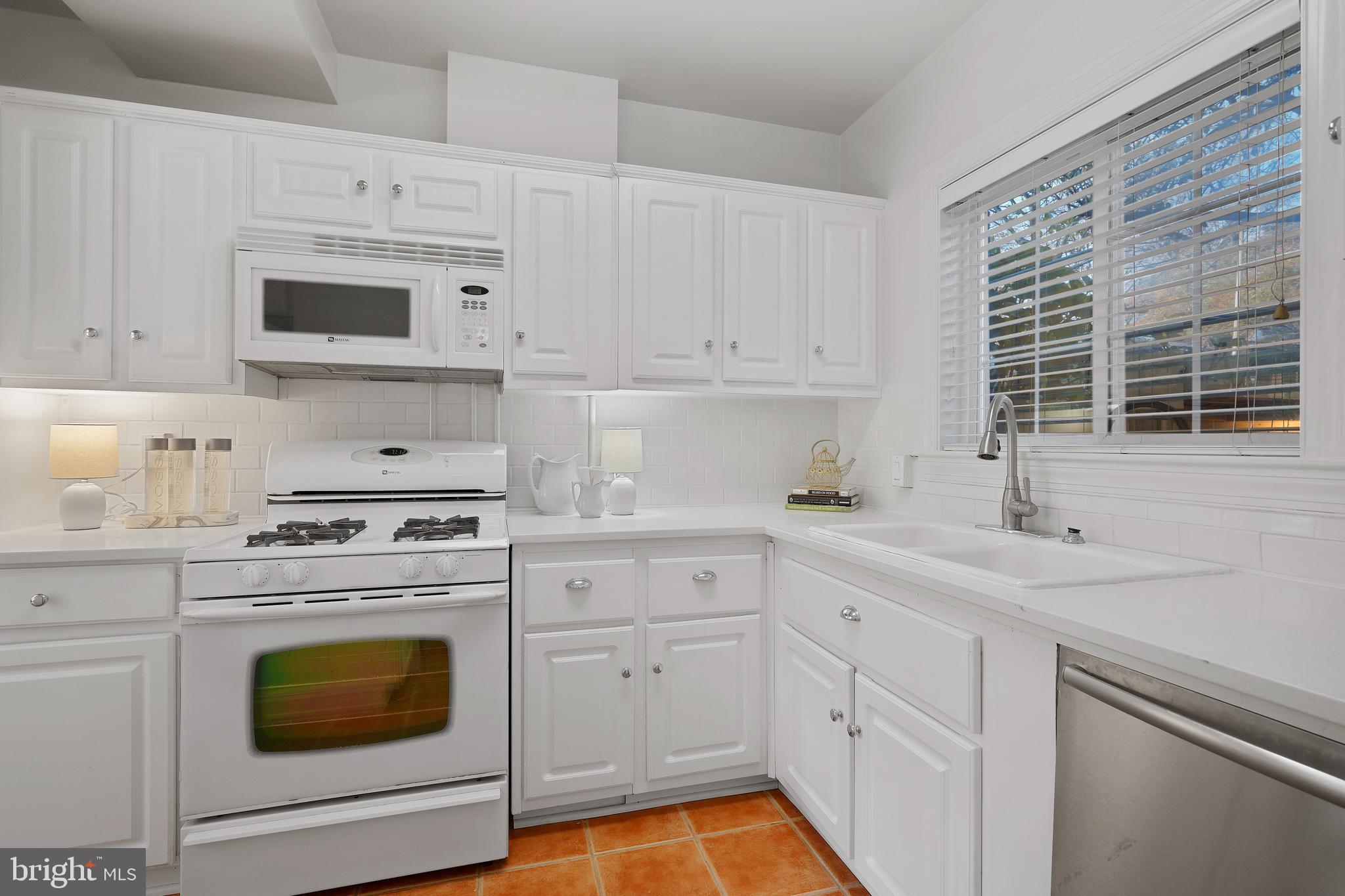 1762 Preston Road Alexandria, VA 22302 - Photo 15 of 34 White kitchen cabinets and countertops.