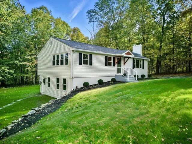 a kitchen with stainless steel appliances granite countertop a sink and a refrigerator