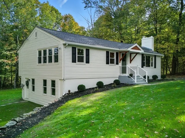 a view of house with backyard