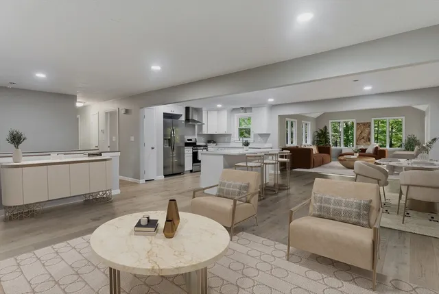 a view of a electric appliances in kitchen and empty room with wooden floor