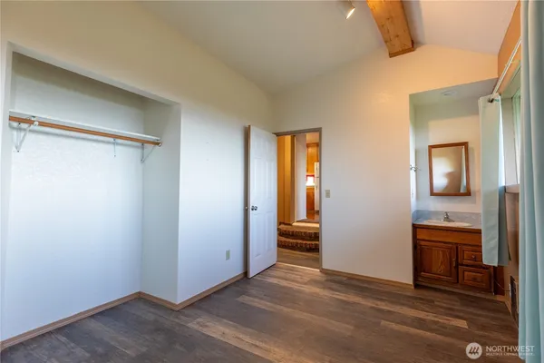 a kitchen with a refrigerator a stove and a wooden floor