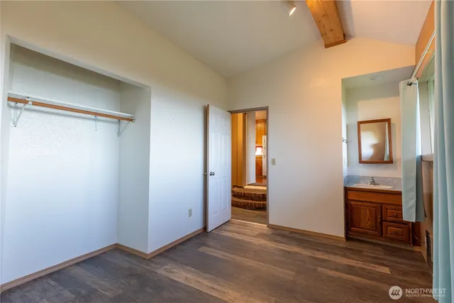 a kitchen with a refrigerator a stove and a wooden floor
