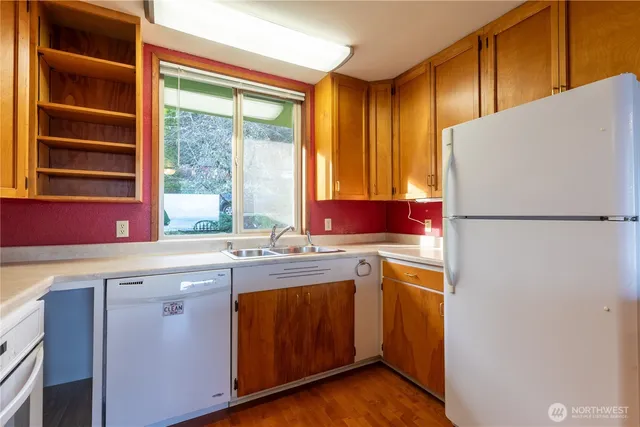 a view of a livingroom with furniture wooden floor and a window