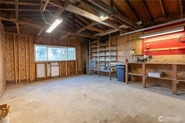 a view of a room with wooden roof and windows