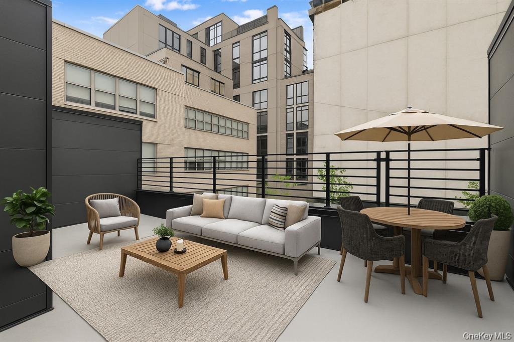 199 East Post Road, Unit 205 White Plains, NY 10601 - Photo 3 of 21 a view of a patio with couches table and chairs under an umbrella