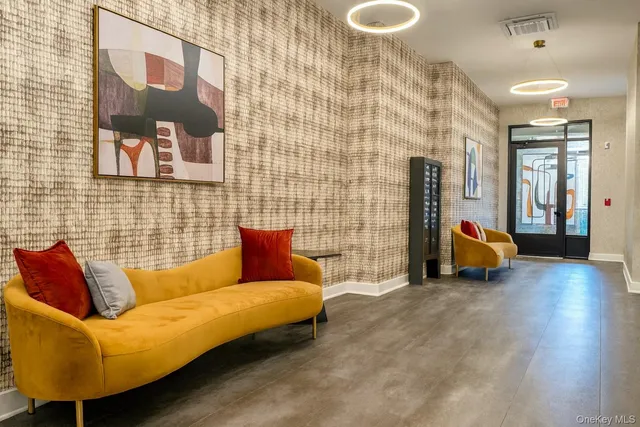 a living room with furniture and a lamp