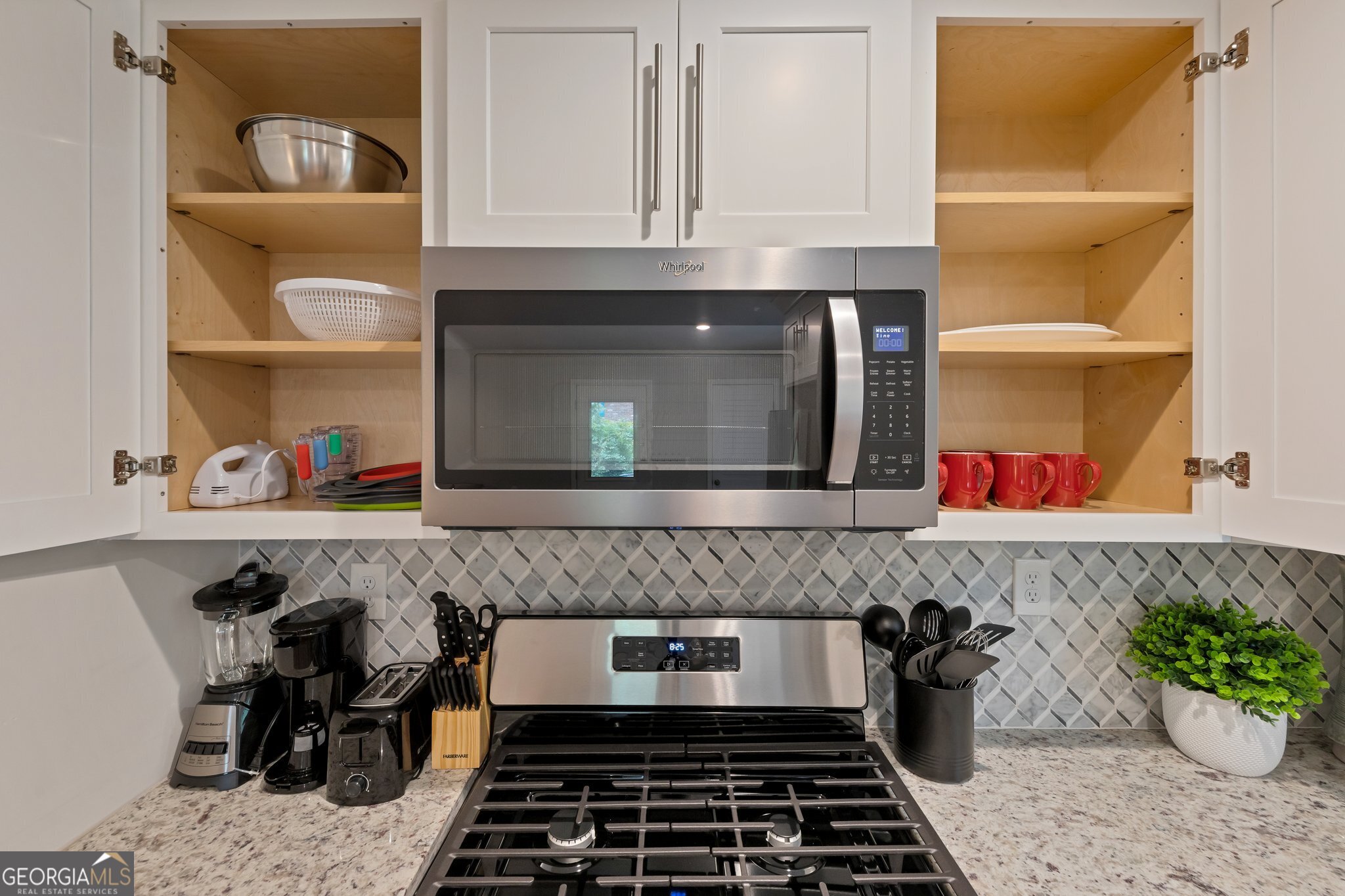 3590 Ponderosa Lane Powder Springs, GA 30127 - Photo 21 of 25 a kitchen with a stove and a microwave