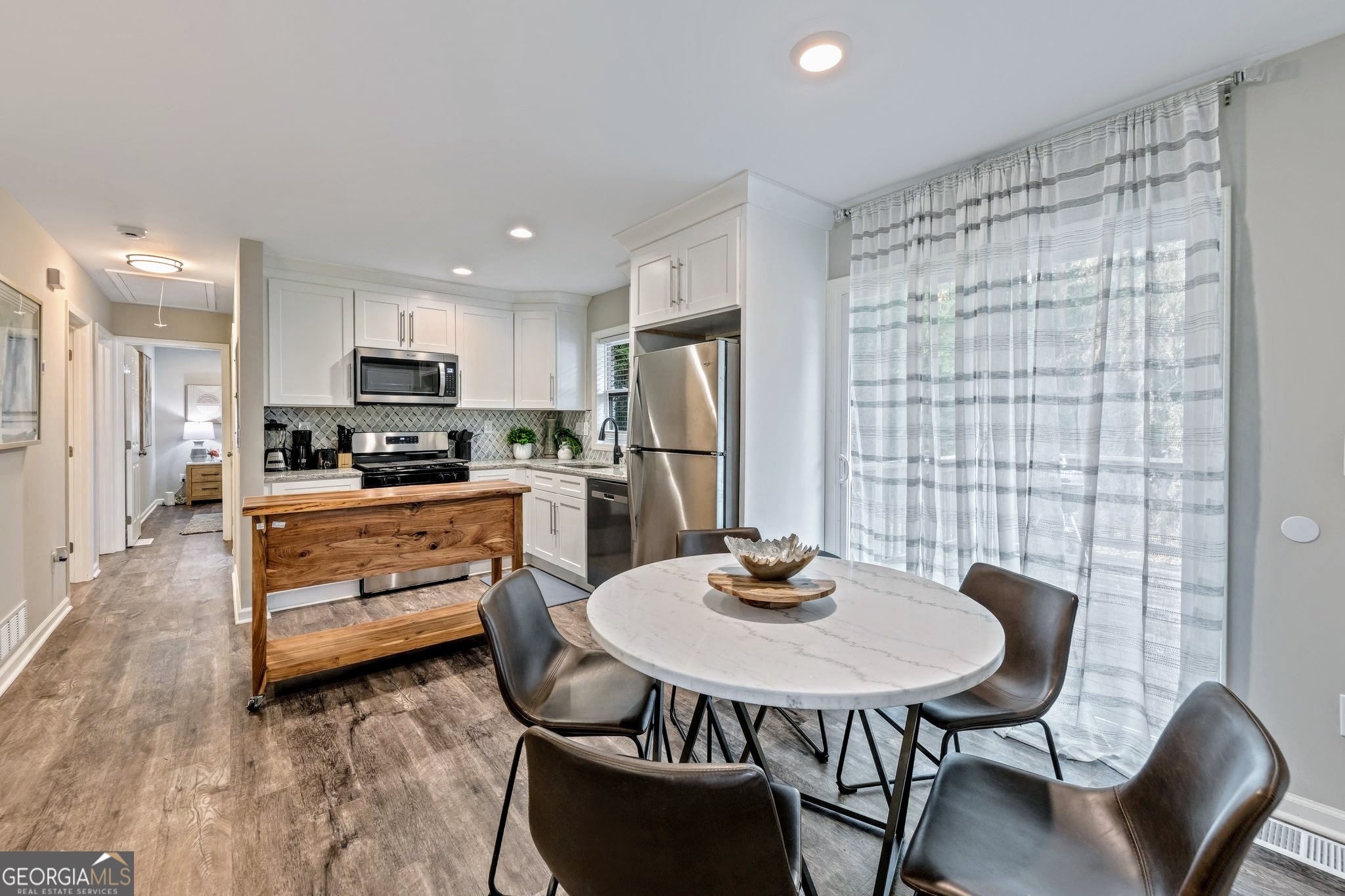 3590 Ponderosa Lane Powder Springs, GA 30127 - Photo 22 of 25 a kitchen with a table and chairs in it