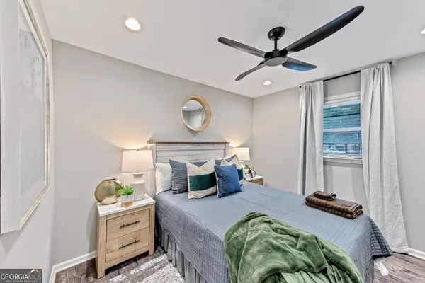 a bedroom with a bed and a chandelier