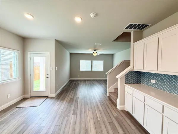 a view of a room with window and wooden floor