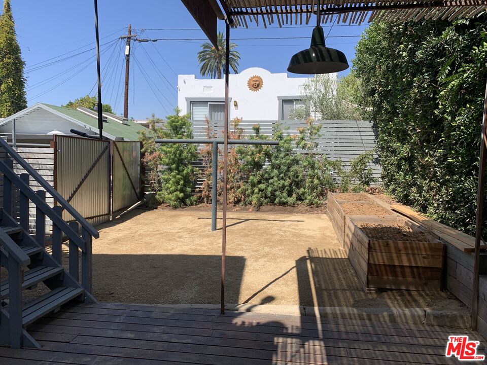 1107 Waterloo Street Los Angeles, CA 90026 - Photo 14 of 20 a view of a patio with table and chairs and wooden floor