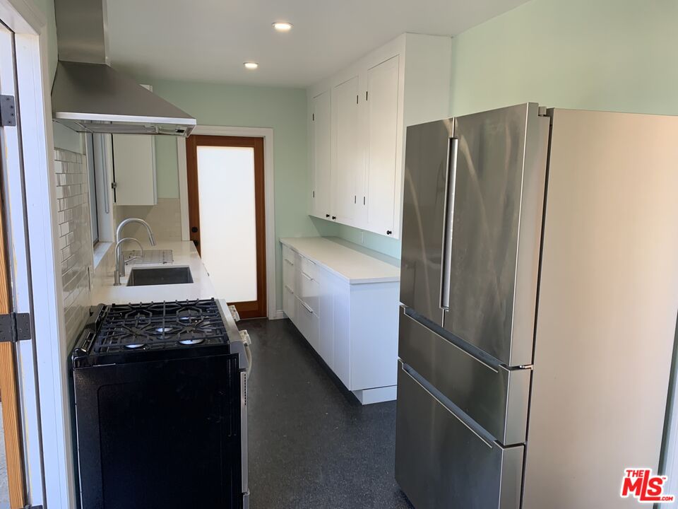 1107 Waterloo Street Los Angeles, CA 90026 - Photo 15 of 20 a kitchen with a refrigerator and a sink