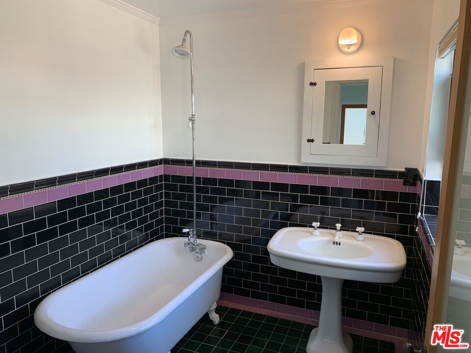 1107 Waterloo Street Los Angeles, CA 90026 - Photo 16 of 20 a bathroom with a sink and a mirror