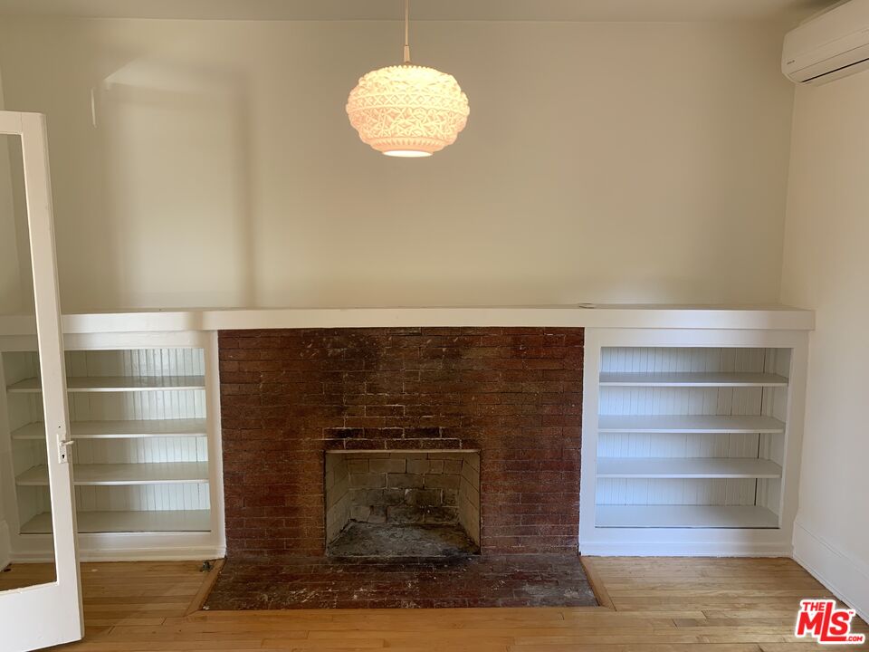 1107 Waterloo Street Los Angeles, CA 90026 - Photo 19 of 20 a view of room with wooden floor and a fireplace