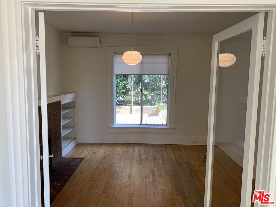 1107 Waterloo Street Los Angeles, CA 90026 - Photo 20 of 20 a view of an empty room with a window and wooden floor
