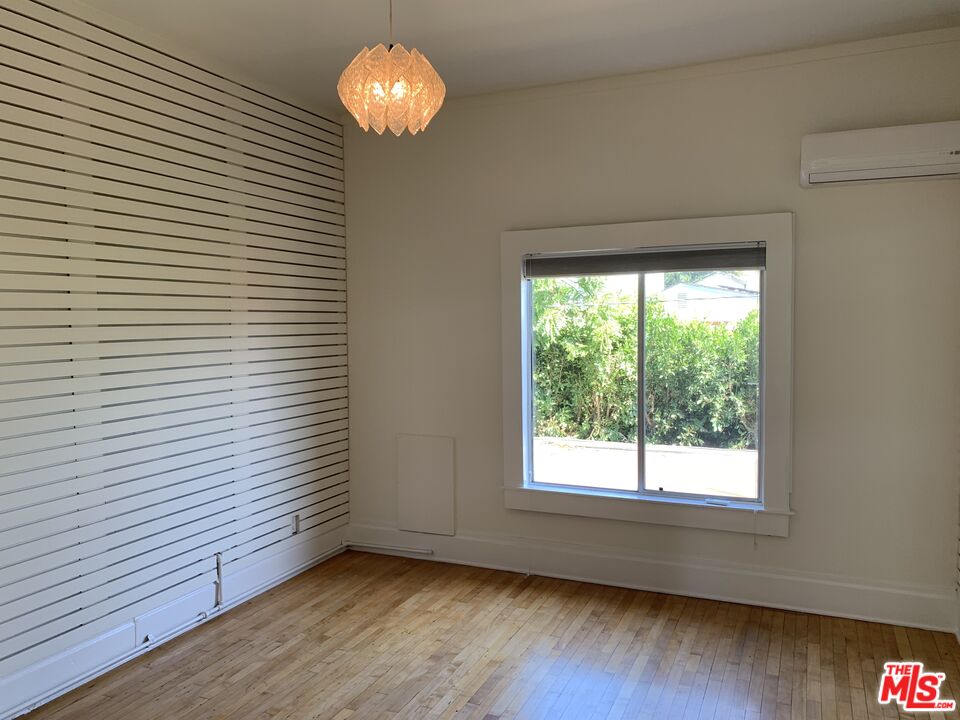 1107 Waterloo Street Los Angeles, CA 90026 - Photo 7 of 20 a view of a room with wooden floor and a window