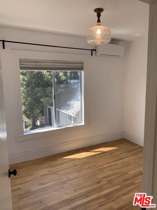 1107 Waterloo Street Los Angeles, CA 90026 - Photo 8 of 20 a view of a chandelier fan and wooden floor