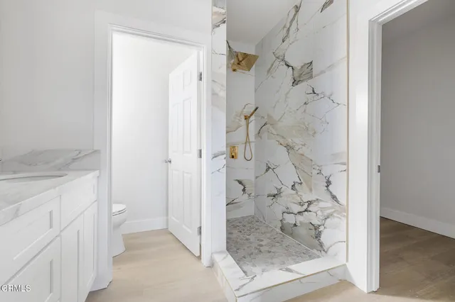 a bathroom with a granite countertop shower mirror and a sink