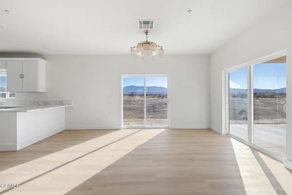 a view of an empty room with a kitchen