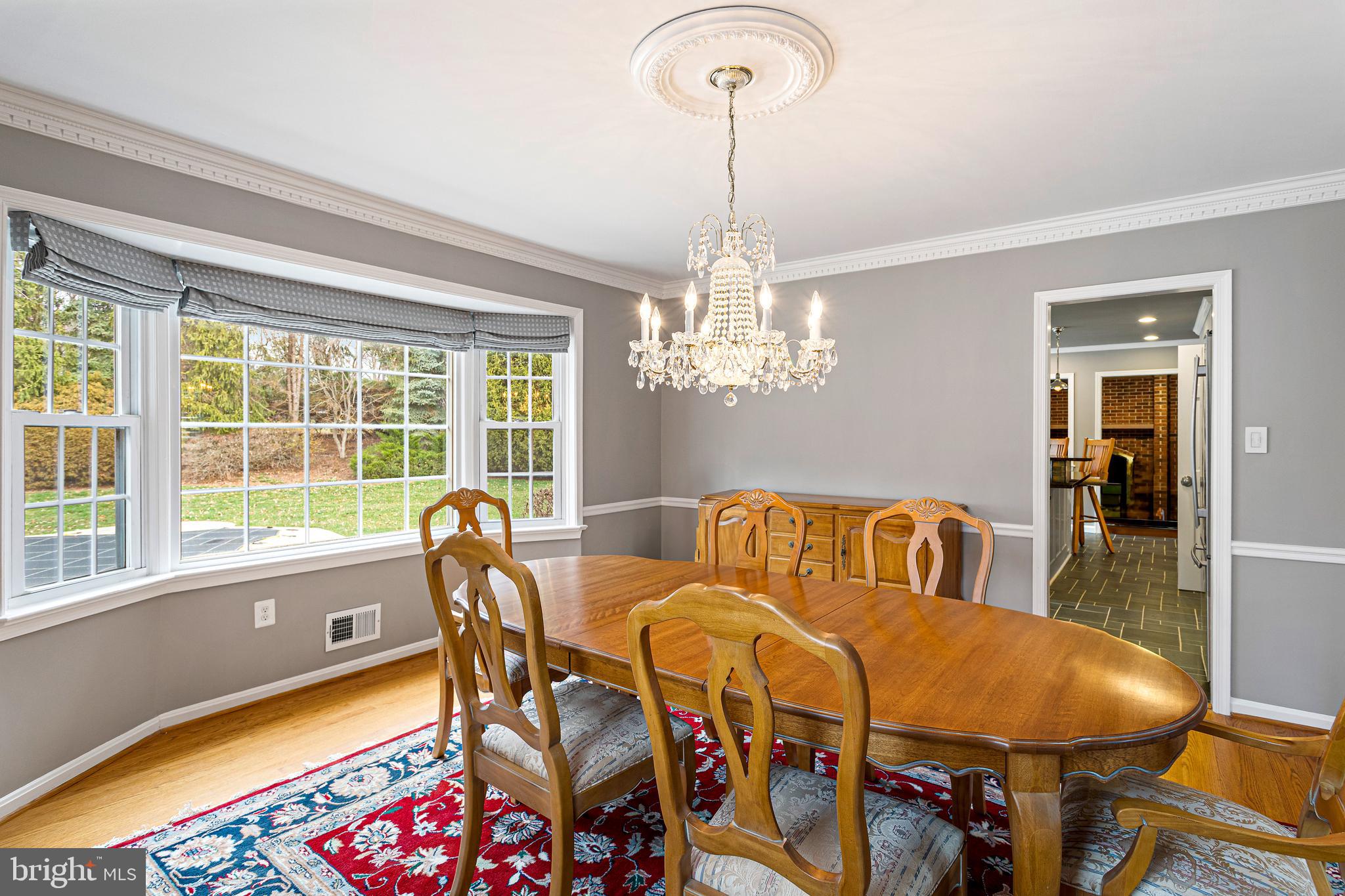 10904 Equestrian Court Reston, VA 20190 - Photo 13 of 81 a view of a dining room with furniture a chandelier and wooden floor